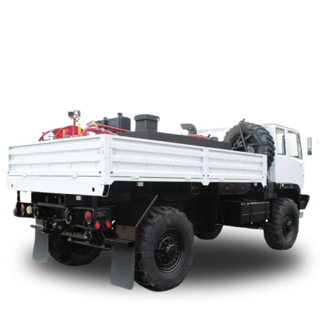 White truck with flatbed and spare tire.