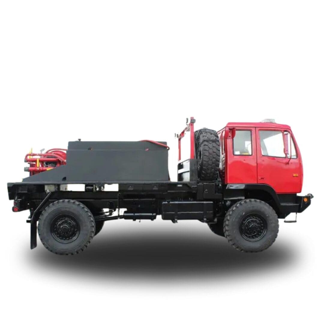 Red flatbed truck with a black tank.