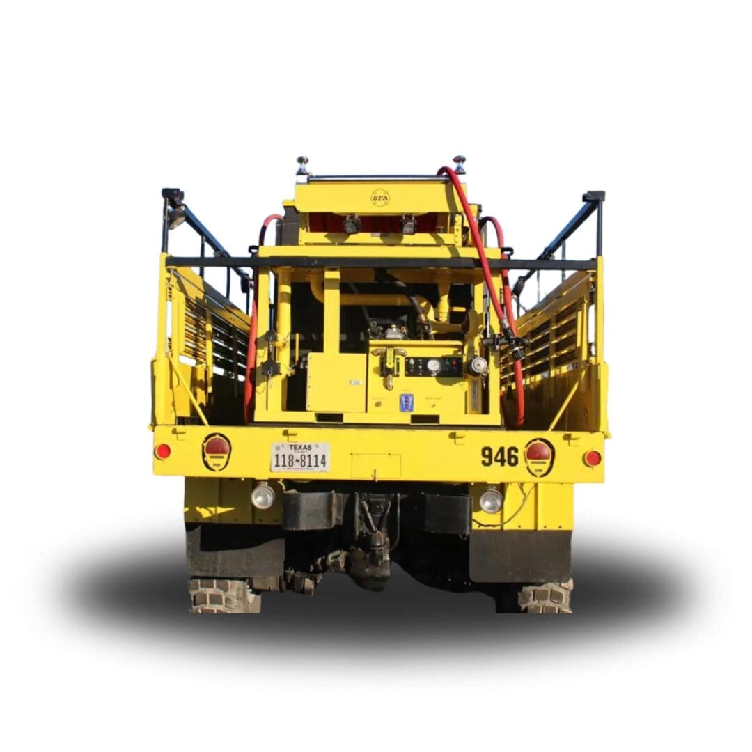 Yellow utility truck with hoses and equipment.